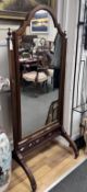 An Edwardian mahogany cheval mirror with fret cut frieze, width 70cm, height 161cm