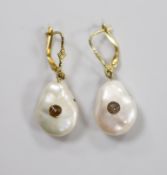 A pair of yellow metal and baroque pearl set drop earrings, each with inset rose cut diamond,