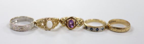 Four assorted modern 9ct gold and gem set dress rings, including single stone amethyst and singe