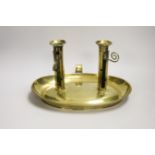 A large brass double chamber candlestick, English c.1800, with oval trap, 33cm wide