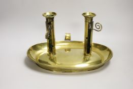A large brass double chamber candlestick, English c.1800, with oval trap, 33cm wide