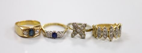 Two yellow metal, sapphire and diamond set three stone rings, one stamped 18ct, size K and two other