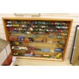 A collection of diecast vehicles in display case