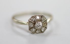A 1920's white metal (stamped Pt) and nine stone diamond set cluster ring, size O, gross weight 2.