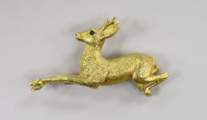A continental textured yellow metal and gem set novelty clip brooch, modelled as a leaping deer,