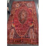 A Caucasian red ground carpet 260cm x 160cm.