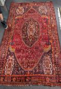 A Caucasian red ground carpet 260cm x 160cm.