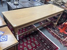 A narrow rectangular topped light oak table, width 180cm, depth 58cm, height 76cm