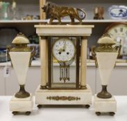 An early 20th century French four glass portico clock garniture, with mercury pendulum, 50cm