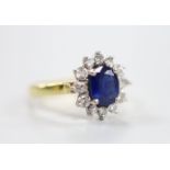 A modern 18ct gold sapphire and diamond set oval cluster ring, size J, gross weight 3.2 grams.