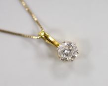 A yellow metal and solitaire diamond set pendant, 15mm, on a 9ct chain, 42cm, gross weight 2.7