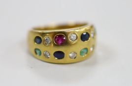 A modern 750 and gypsy set two row, ruby, emerald, sapphire and diamond half hoop ring, size K,