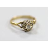 An 18ct and diamond cluster ring, size O, gross weight 2.7 grams.