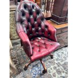 A Victorian style swivel desk chair, width 63cm, height 110cm