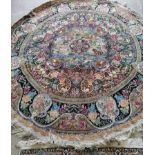 A Tabriz style circular rug woven with animals and birds within panels of fruit and flowers,