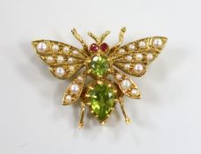 A modern 9ct gold peridot, seed pearl and ruby set novelty bug brooch, width 25mm, gross weight 3.