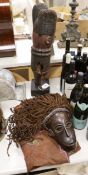 A Massai apron, dan mask and an African carving
