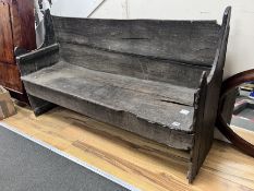 An 18th century rustic oak bench, length 142cm, depth 40cm, height 84cm