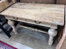 A Flemish style pine two drawer table, on bulbous end supports, width 122cm, depth 61cm, height