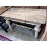 A Flemish style pine two drawer table, on bulbous end supports, width 122cm, depth 61cm, height