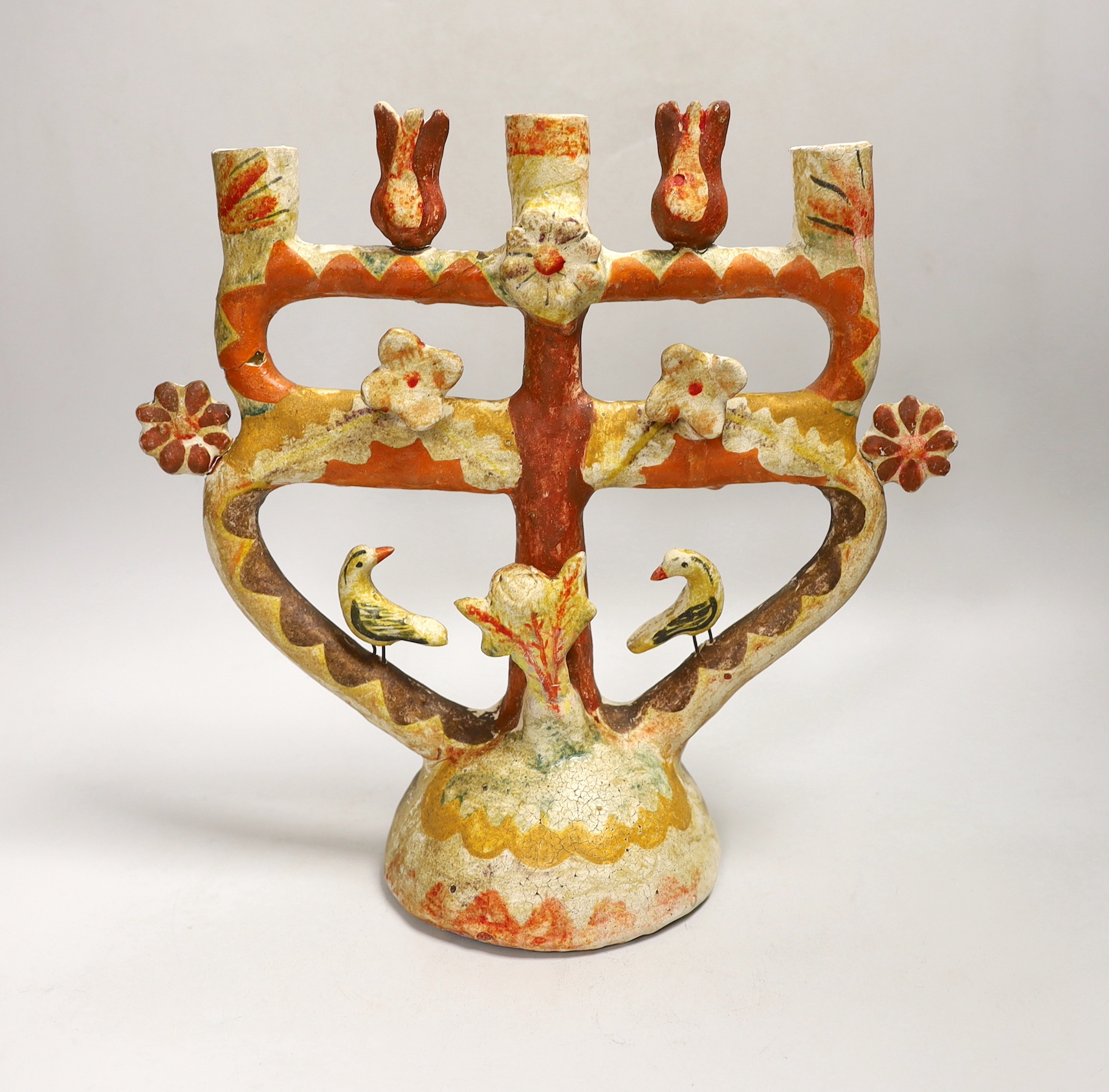 A Mexican Tree of Life painted terracotta candelabrum, 28cm high
