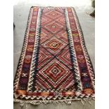 A Kelim polychrome flat weave carpet, 288 x 138cm