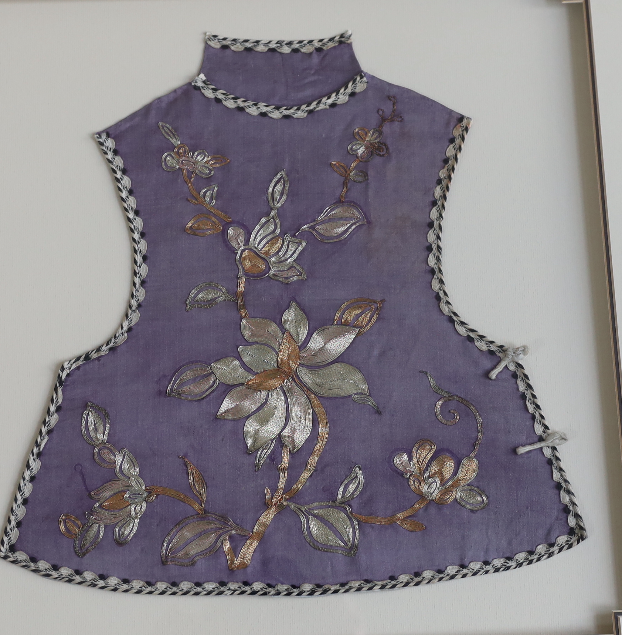 A late 19th century Chinese child’s purple silk and multi-coloured metal embroidered tabbard, - Image 3 of 3