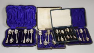 Three assorted cased sets of six silver tea or coffee spoons, one with tongs and other incomplete