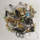 A box of costume jewellery including silver brooches and pendants.
