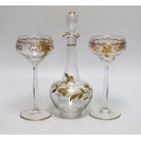 A Continental Art Nouveau gilt glass decanter and a pair of similar glasses, decanter 24cm high