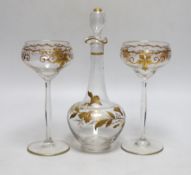 A Continental Art Nouveau gilt glass decanter and a pair of similar glasses, decanter 24cm high