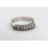 A modern white metal and seven stone diamond set half eternity ring, size L/M, gross weight 4.2