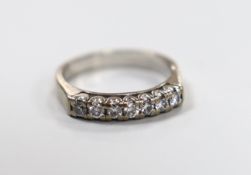 A modern white metal and seven stone diamond set half eternity ring, size L/M, gross weight 4.2