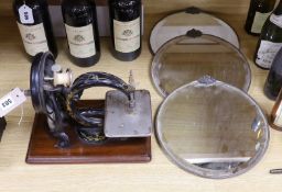 A Willcox & Gibbs sewing machine, and a set of three circular bevelled wall mirrors, 31cm