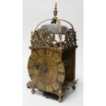 An English brass lantern clock with four branch finial decoration signed Tho Moore of Ipswich,