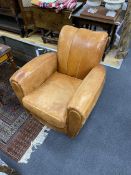 A pair of mid century tan leather club chairs, width 86cm, depth 90cm, height 78cm