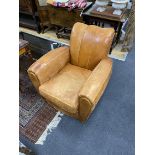 A pair of mid century tan leather club chairs, width 86cm, depth 90cm, height 78cm