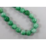 A single strand jade bead necklace, with white metal clasp, beads approximately 14mm in diameter,