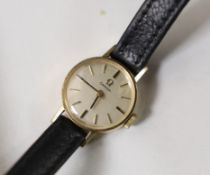 A lady's 1960's 9ct gold Omega manual wind wrist watch, on a leather strap with Omega buckle, the