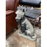 A reconstituted stone garden ornament modelled as an Alsatian puppy, height 66cm