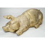 A large hollow cast brass model of a recumbent pig, 47cm long