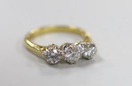 A 1970's 18ct gold and three stone diamond set ring, size O/P, gross weight 4.7 grams, the central