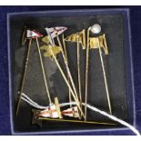 Five assorted 9ct and enamelled pennant stick pins, a yellow metal, a ruby and diamond set pennant