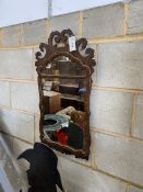 An 18th century style walnut and parcel gilt fret carved wall mirror, width 41cm, height 72cmNB: