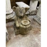 A reconstituted stone garden fountain modelled as a bear with a honeypot, height 37cm