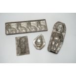 Four chocolate mould tins: a cat, a kewpie and two others
