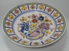 An 18th century Delft polychrome charger, 35cm diameter