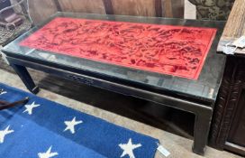 An Asian red stained hardwood coffee table, length 142cm