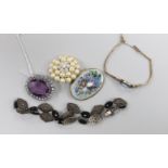 A small group of assorted costume jewellery including marcasite necklace, amethyst paste brooch,