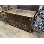 An 18th century panelled oak mule chest, width 122cm, depth 57cm, height 74cm